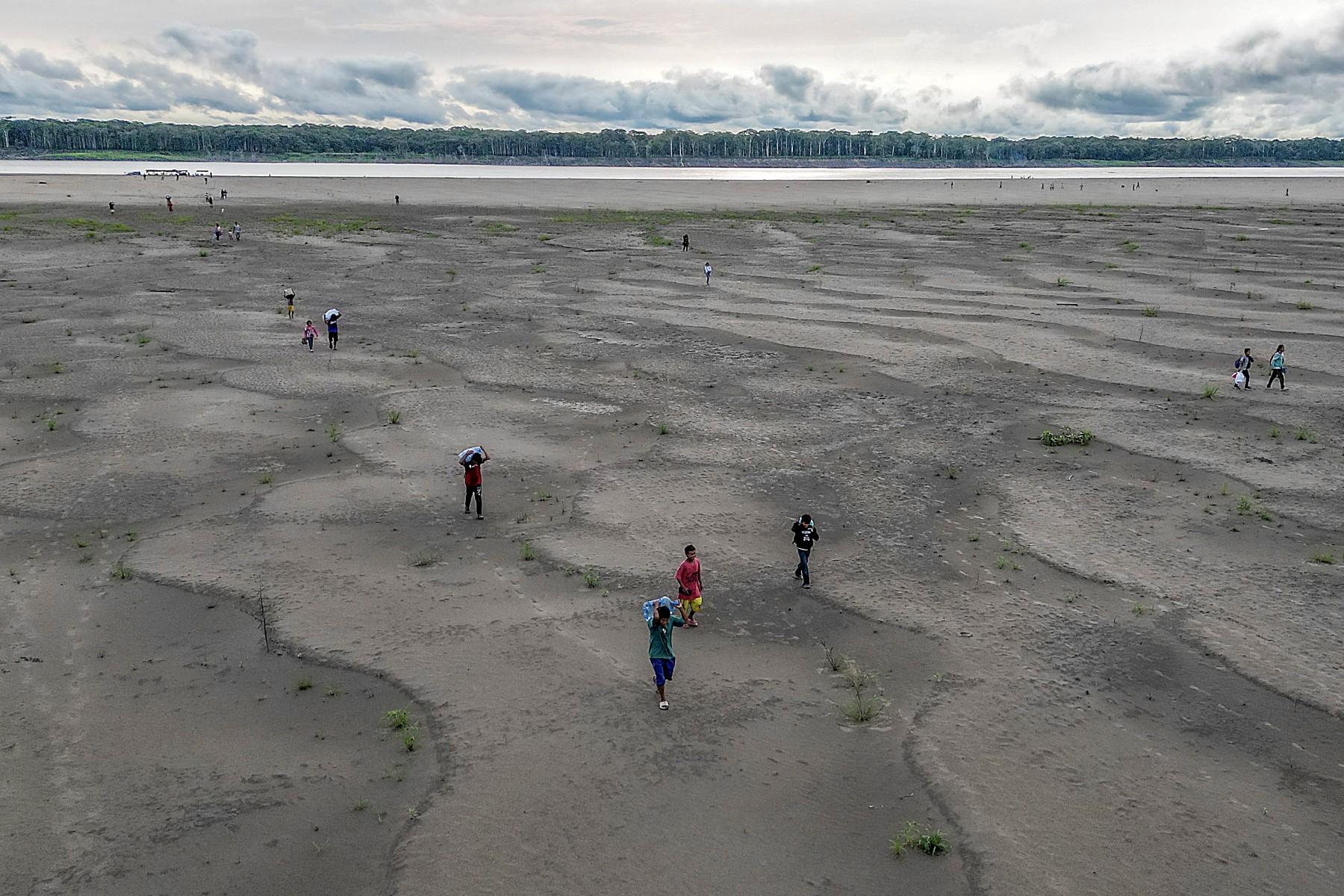 People walking on a dry riverbed