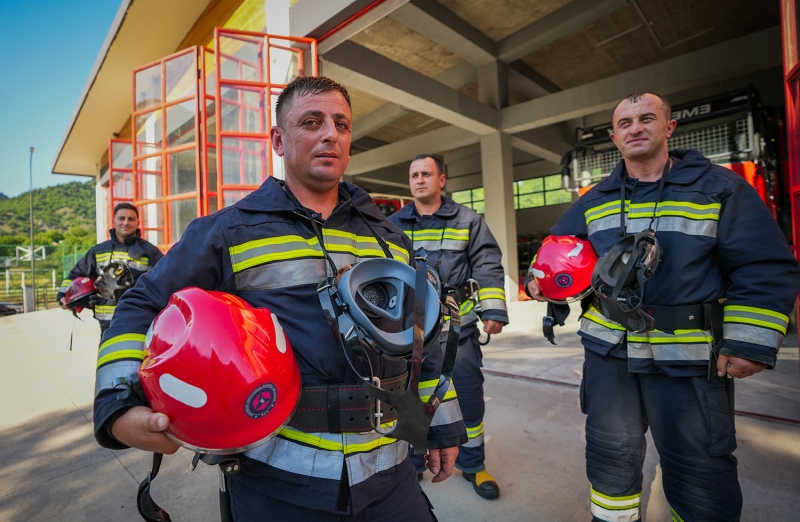 Three firefighters pose for a photo