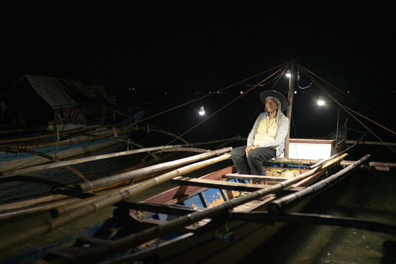 Analyn Fedelis in her boat with solar lights and radio. 
