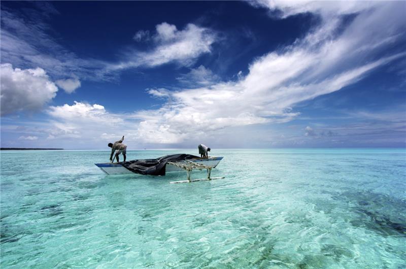 Two individuals fishing in the ocean