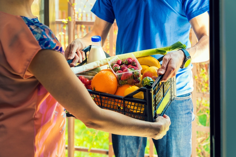 A person receives groceries.