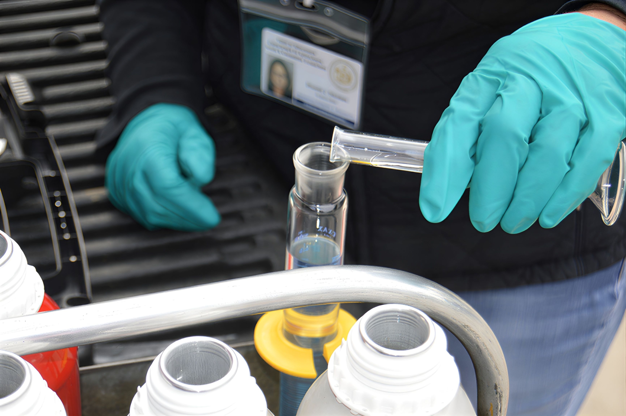 A technician collects fuel sample