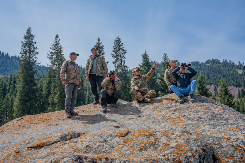Men standing on a rock