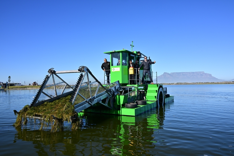 Cape Town Mayor Geordin Hill-Lewis (right) and Deputy Mayor Eddie Andrews on board one of three weed-harvesting machines helping to restore some of the city's wetlands.