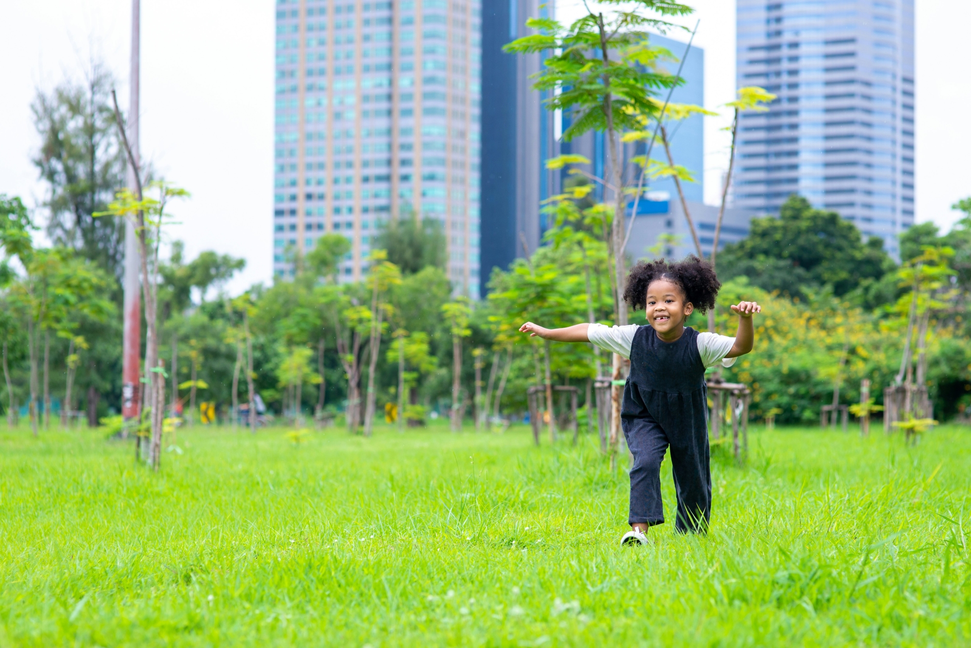 photo of child running in city