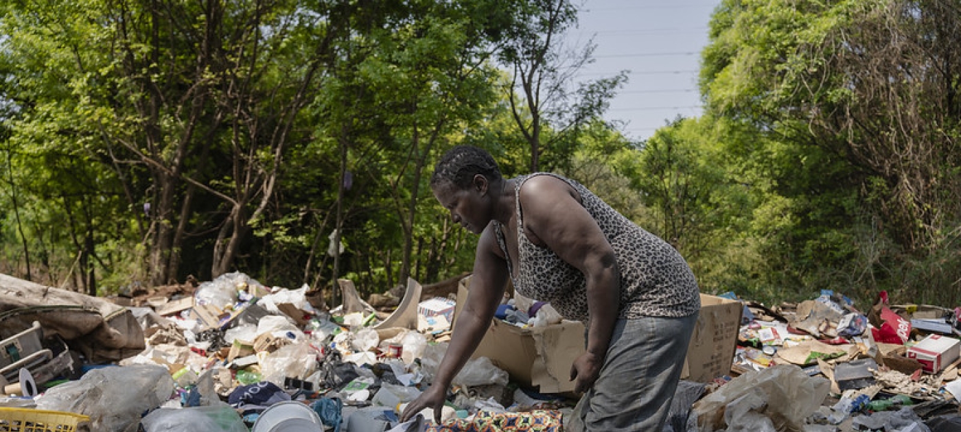 a woman in a dumpsite