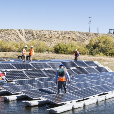 Workers install solar panels