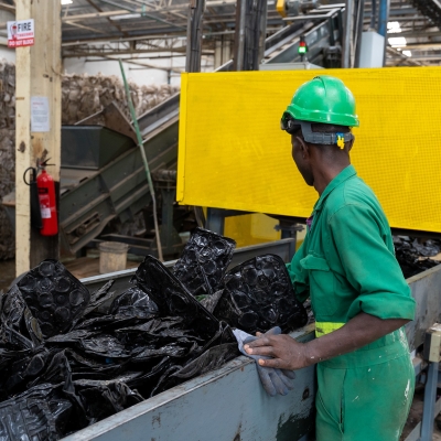 A worker in a recycling or waste processing facility.