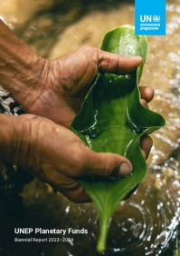 A close-up photograph of a hand holding a green leaf
