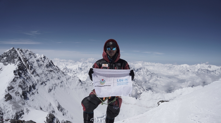 A man at the summit if Mount Everest