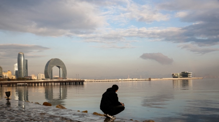 A man standing by the water