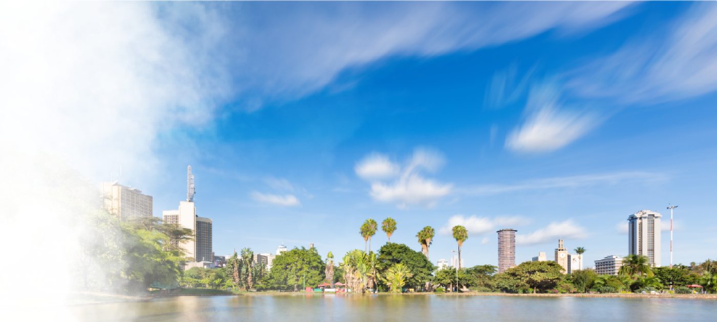 Long exposure of the skyline of Nairobi, Kenya with the beautiful lake in Uhuru Park in the foreground and some blurred boats.
