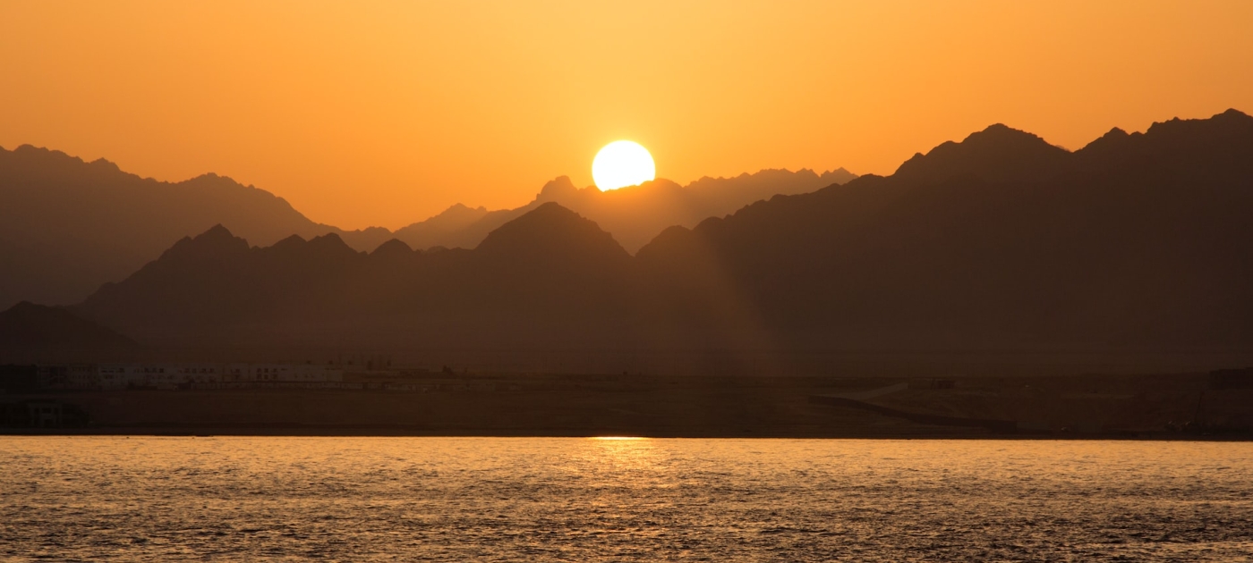 Silhouette of mountain under sunrise