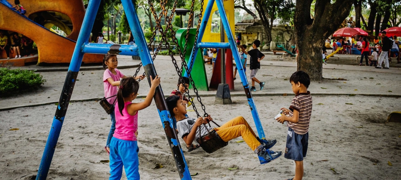 Children playing on a swing