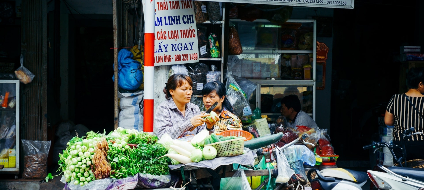 Woman with vegetables on her bike