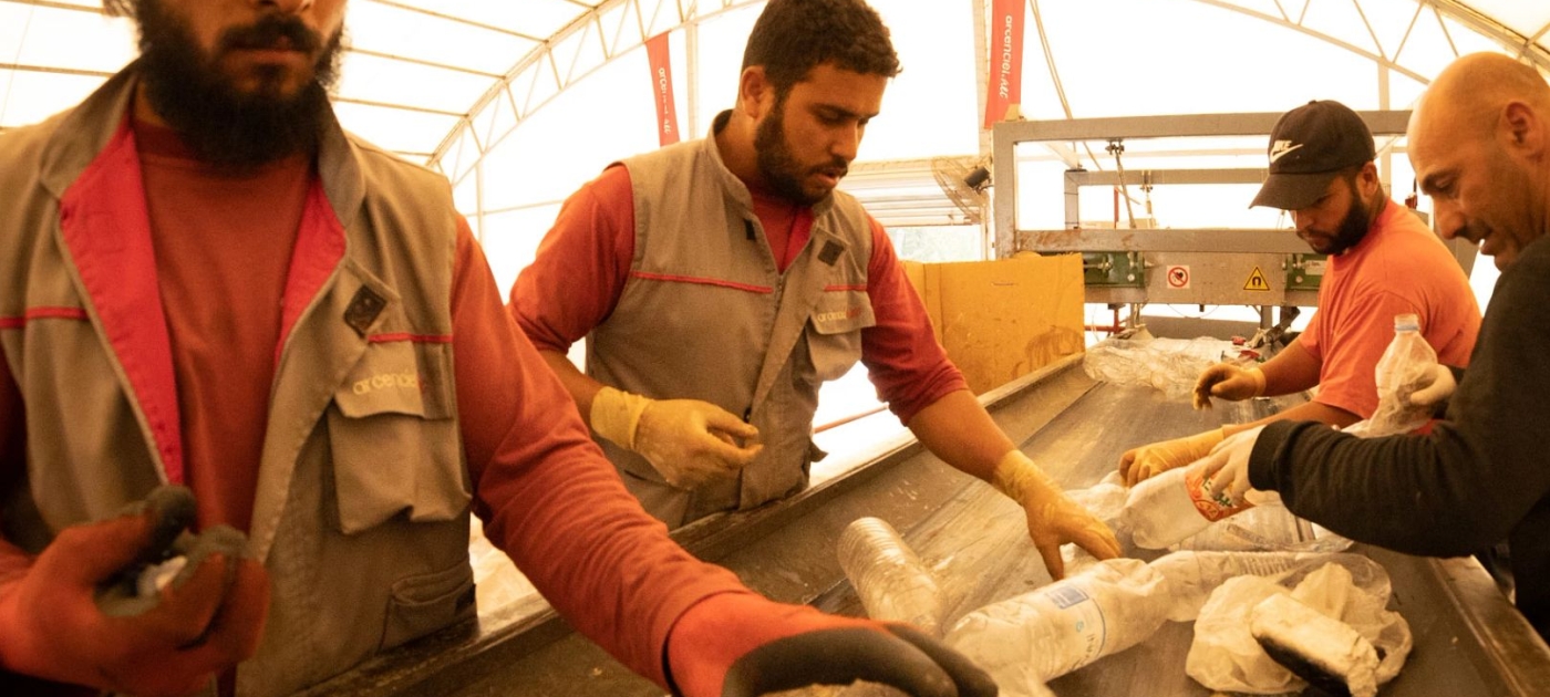 People sorting plastic on a conveyor belt