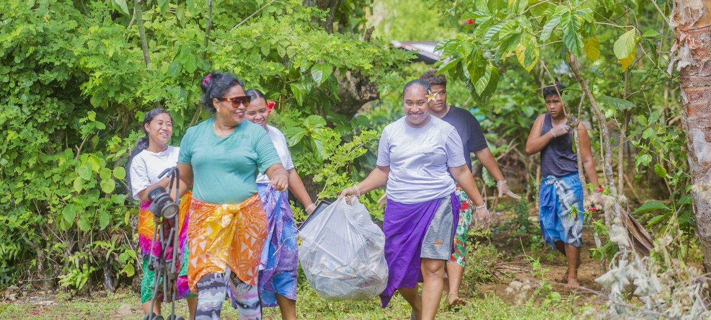 people carrying a trash bag