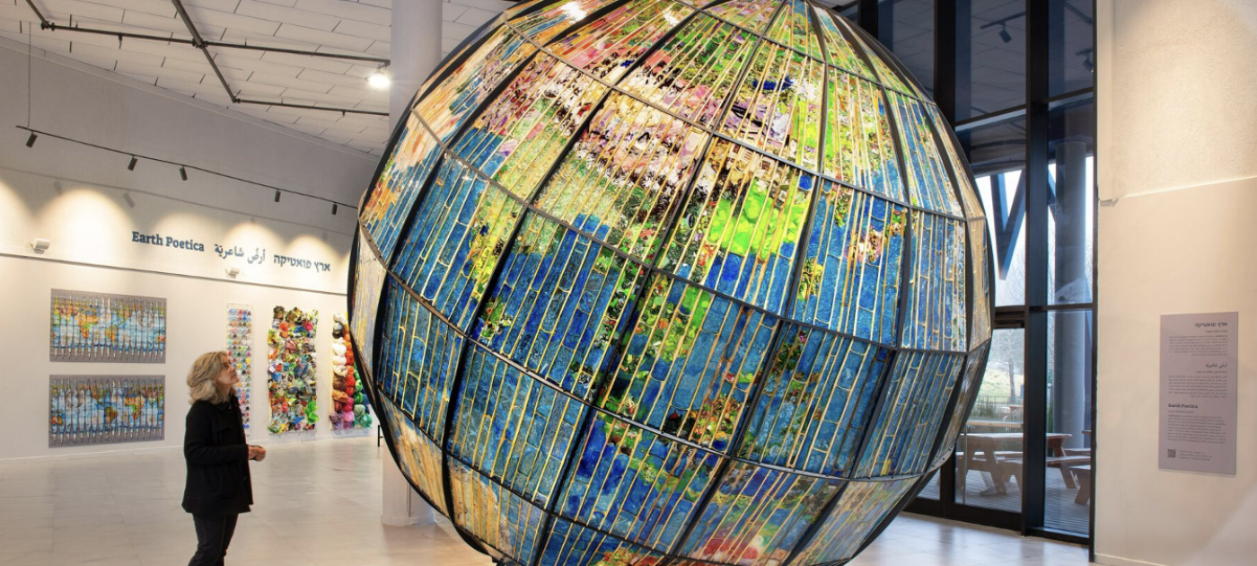 A large planet Earth made out of plastic waste. 