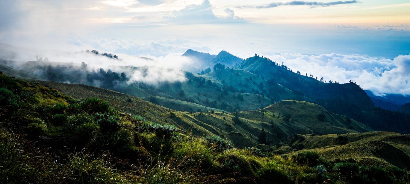 Green hills in Indonesia with clouds rolling in 