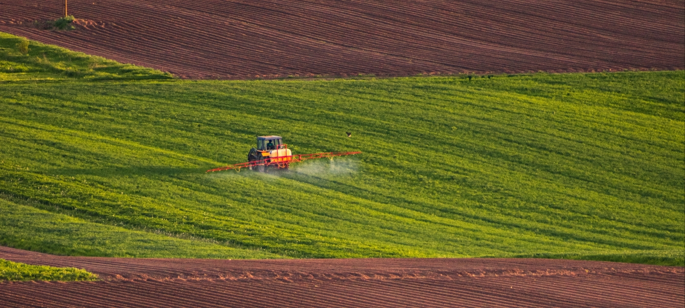 Tractor spraying in a large field