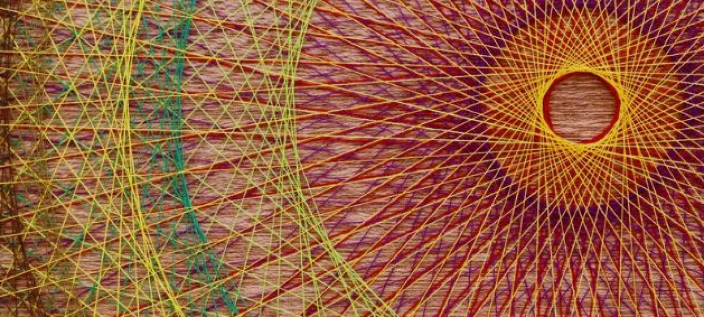 Yellow, red, green and purple threads, interwoven in a circle