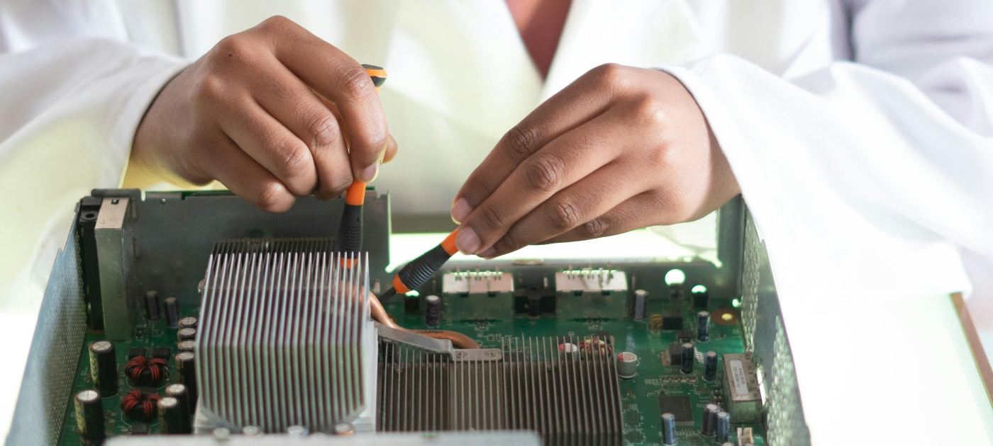 Youthful lady fixing graphics card on computer