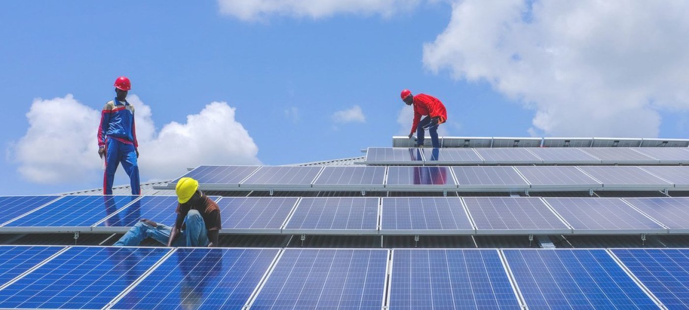 Men installing solar panels on a roof