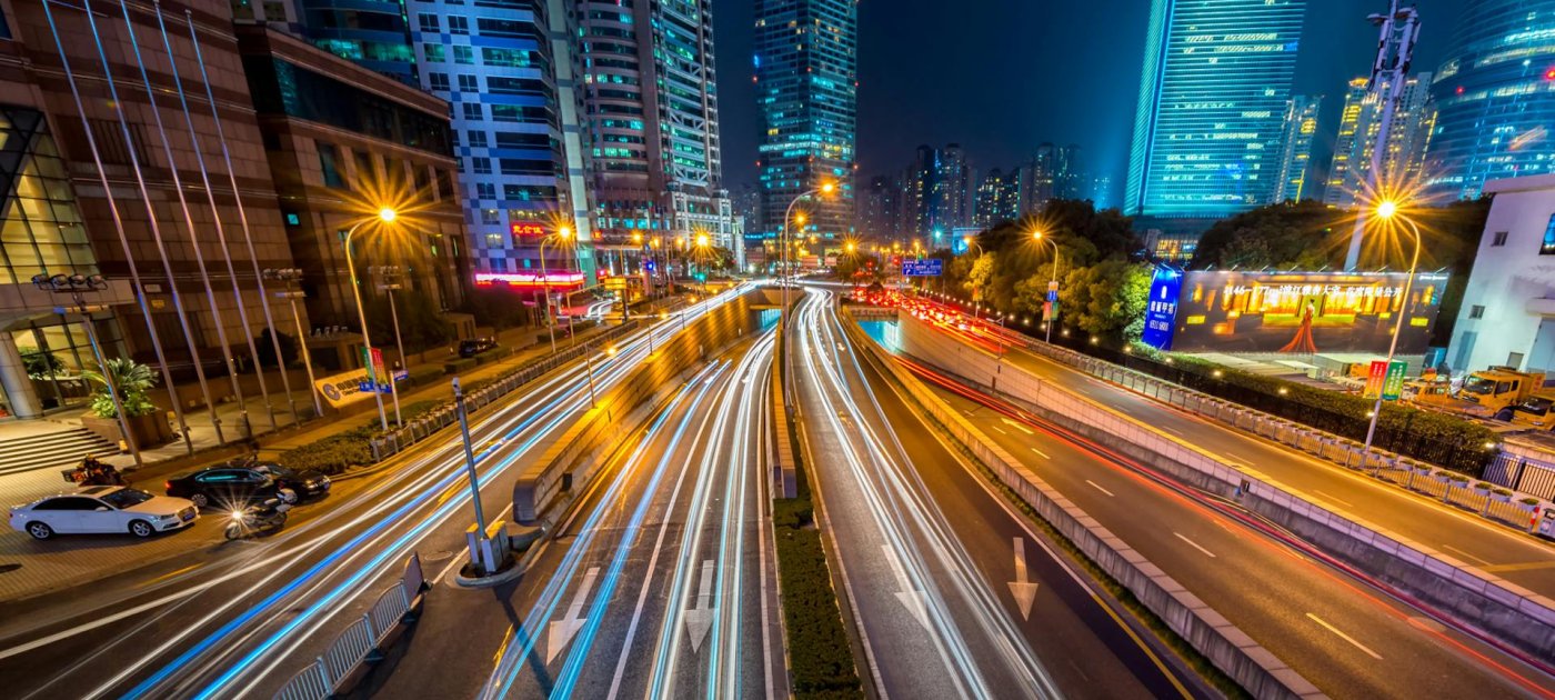Timelapse Photography of Vehicle on Concrete Road Near in High Rise Building during Nighttime