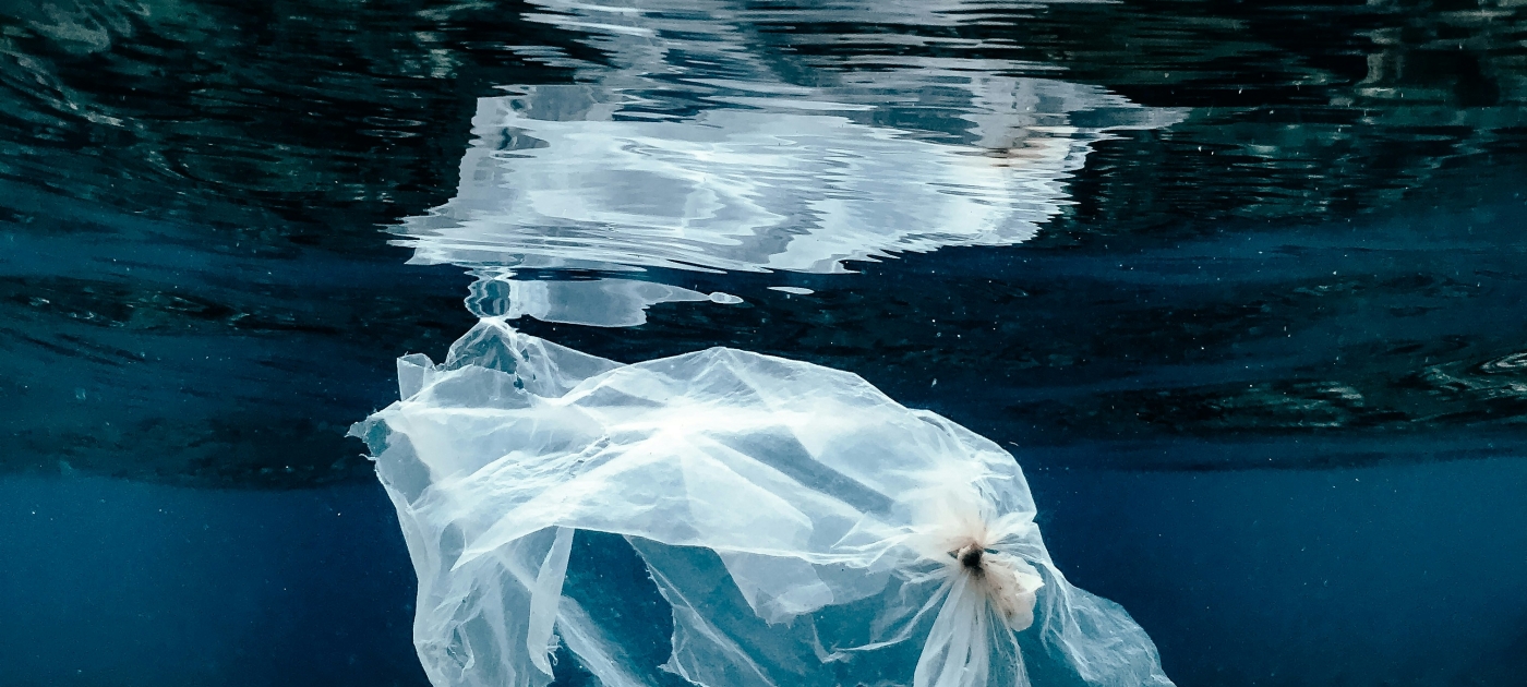 A single use plastic bag floating underwater near the surface in Bali, Indonesia