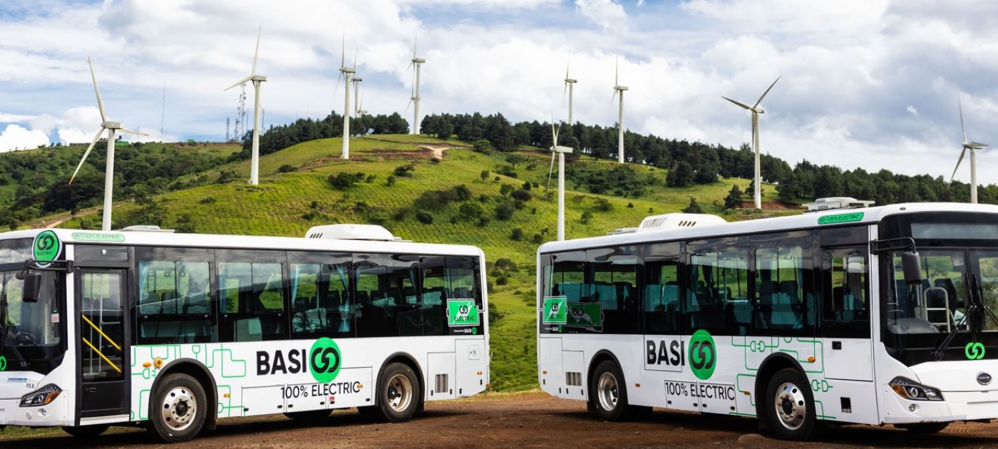 Electric buses in a field of grass