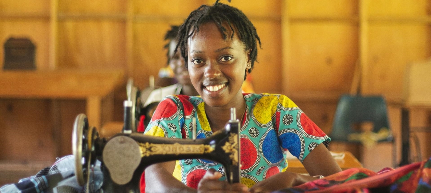 Woman seated near a sewing machine