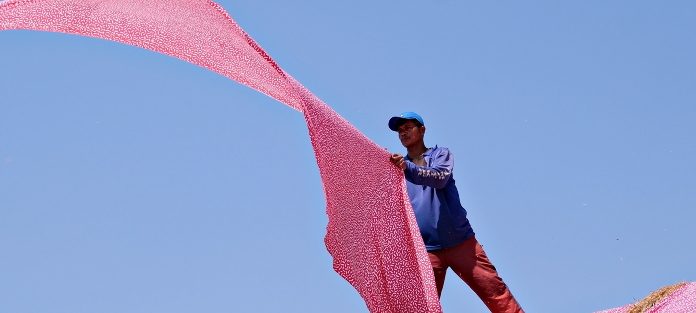 A man holding a long fabric