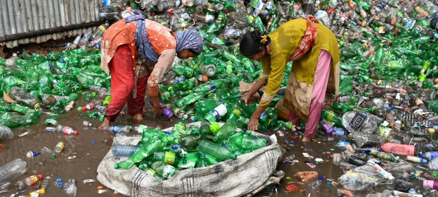 Women picking plastic bottles