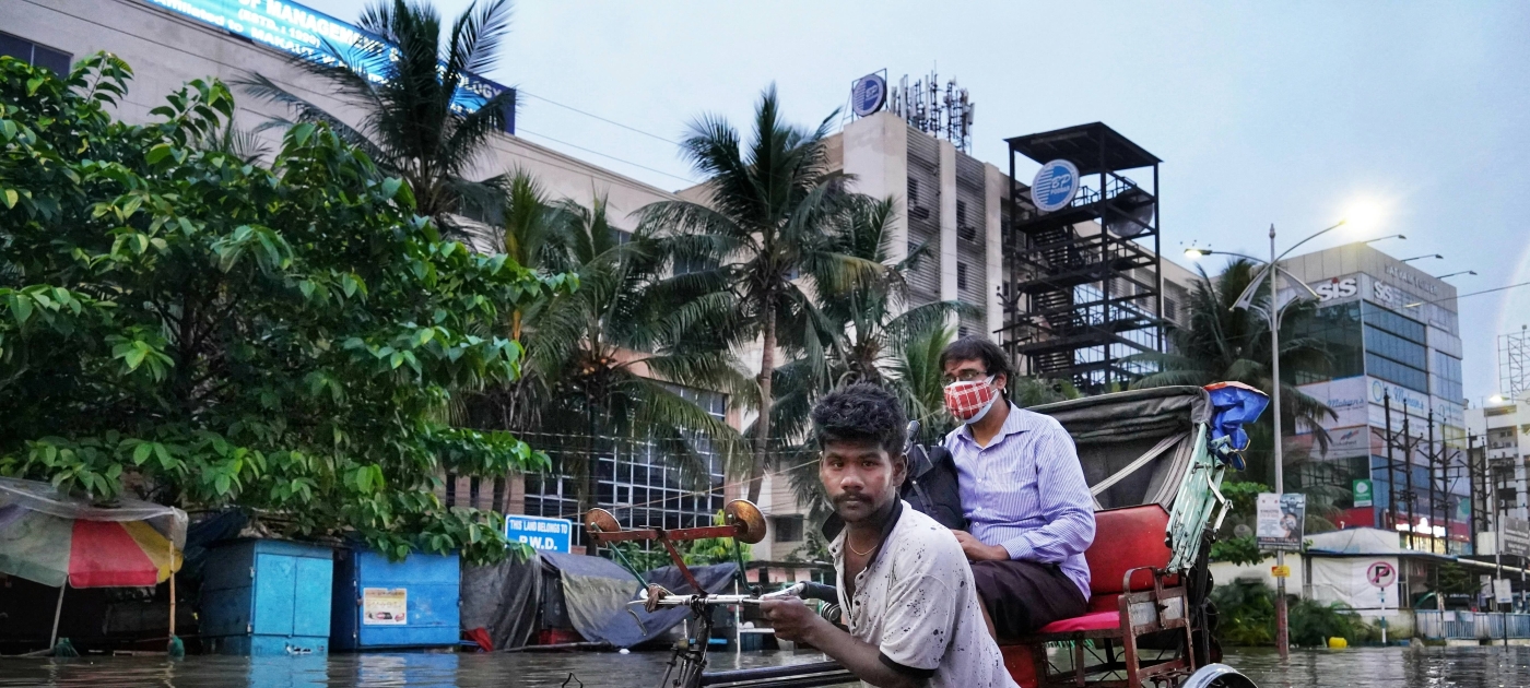 Men standing in flooded street in India 