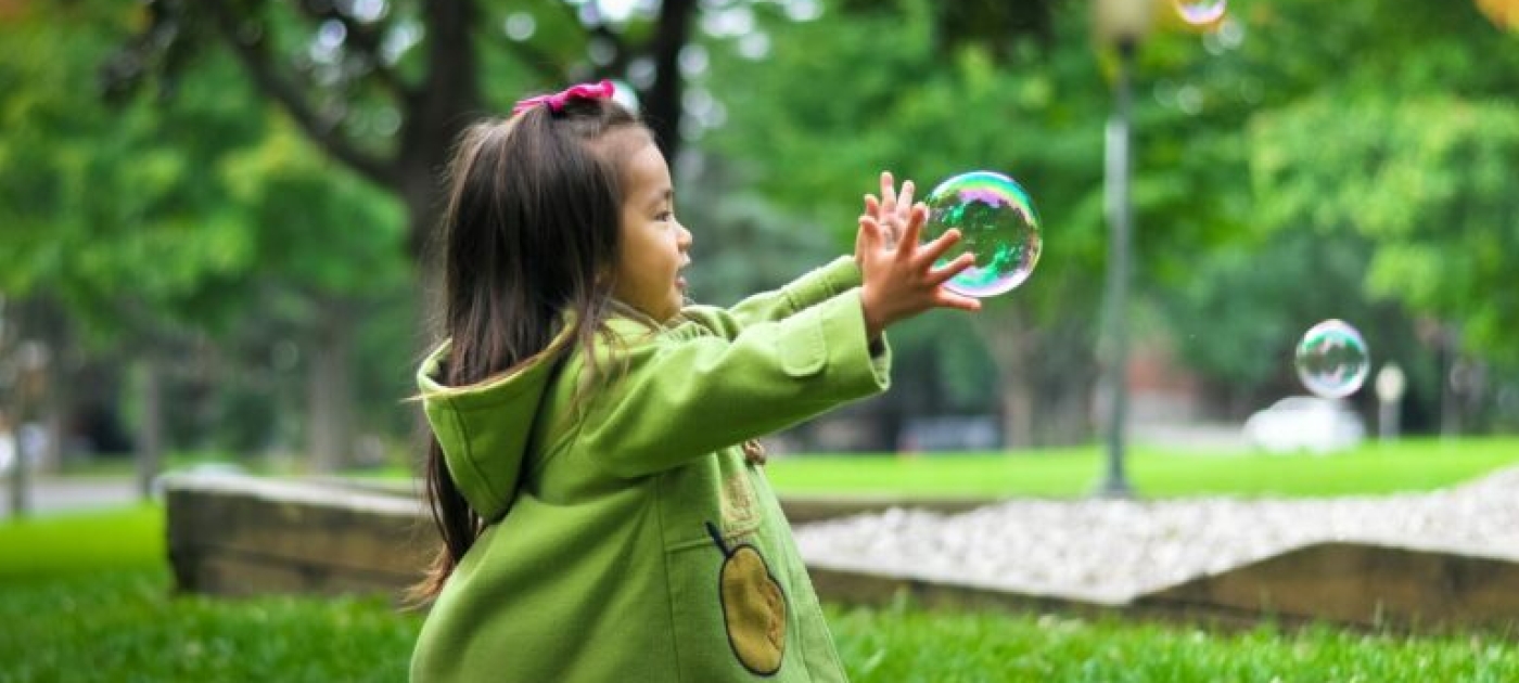 child running after a soap bubble