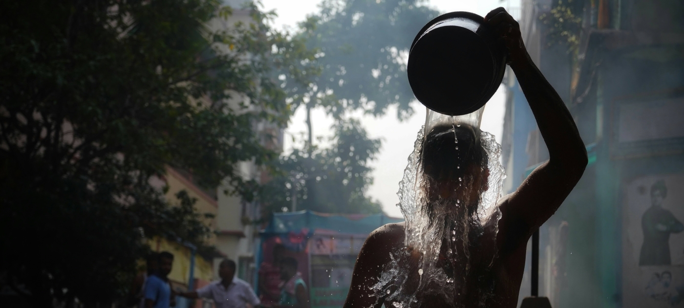 Cooling down with bucket of water in extreme heat