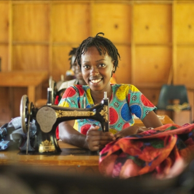 Woman seated near a sewing machine