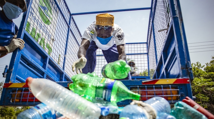 Two men recycle plastic bottles in Nairobi, Kenya.