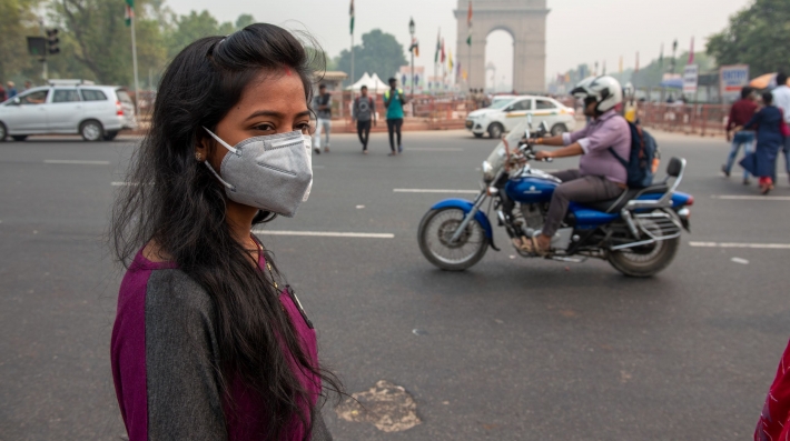 A woman stands on a street in New Delhi 