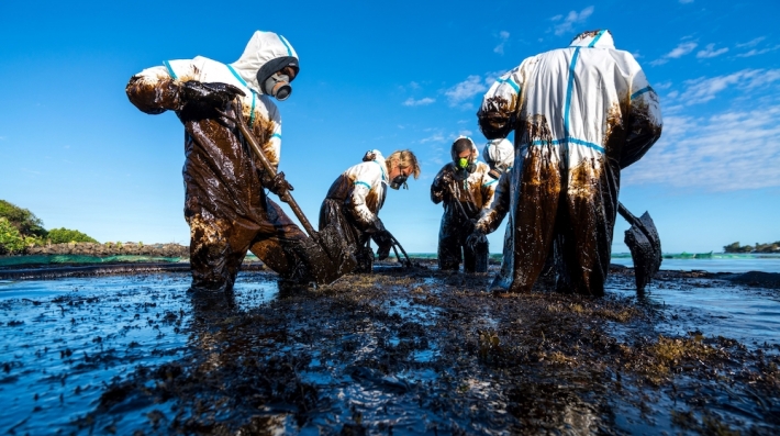 Workers clean up an oil spill.