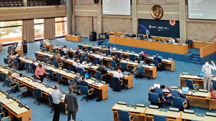 People attend a meeting in a conference hall.