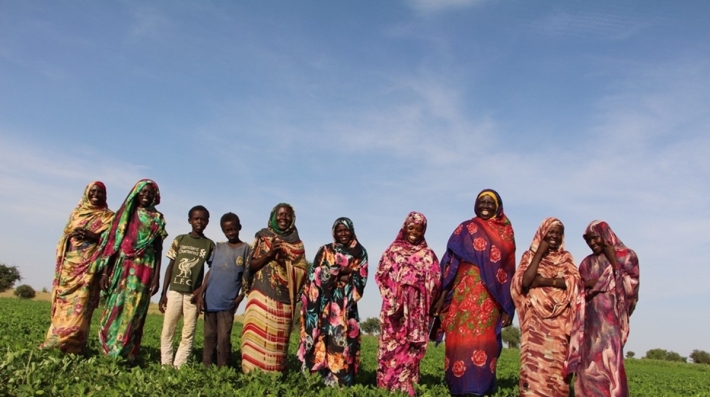 A group of women standing in a field.