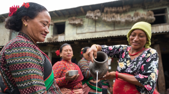 Women gather around and have tea