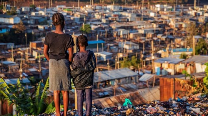 Two children look out over a slum