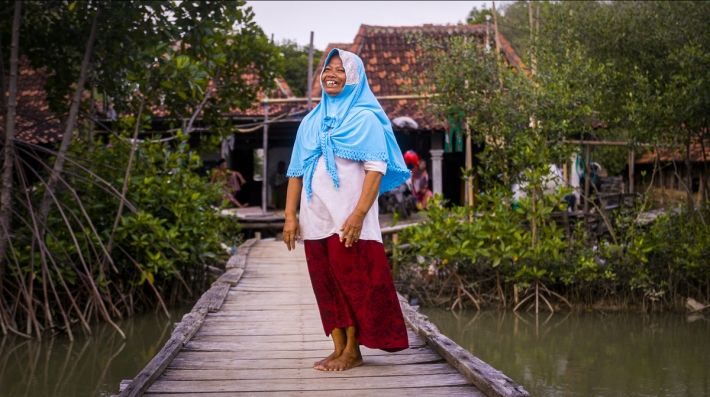 A woman stands on a dock.