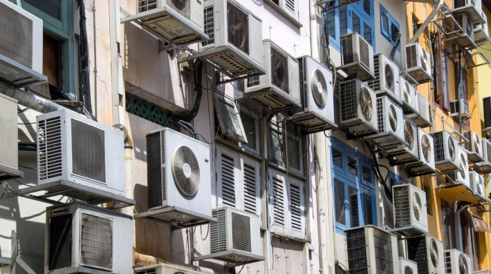 Air conditioners cover the rear of a building