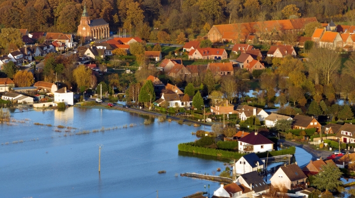 Floodwaters surround a village