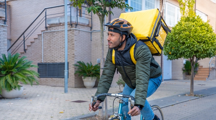 A man rides for bike delivery. 