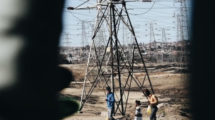 A group of people next to a power line