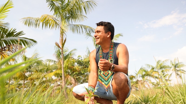 A man stands in a crop field